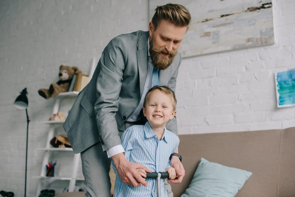 Work-life balance — a man in a suit playing with his child
