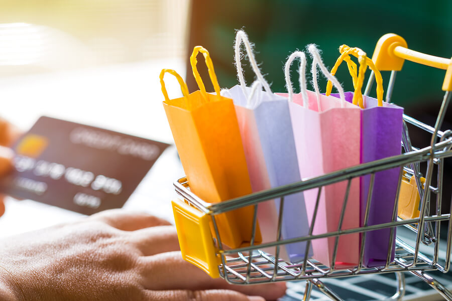 A picture of miniature shopping bags in a trolley. 