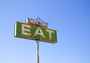 Concept image of an old EAT cafe sign in the US.