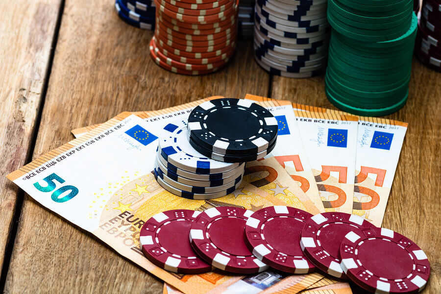 Casino chips sit on top of euro cash notes.