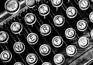 Old typewriter keys. Concept of old content being updated for modern practices.